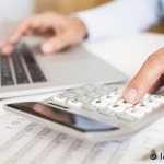 Man with computer and calculator